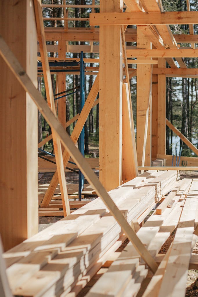 Sunlit construction site with wooden lumber arranged in rows. Perfect for building projects.